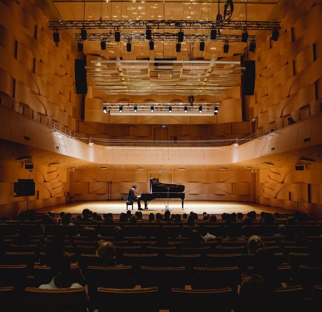 People listening pianist at concert hall