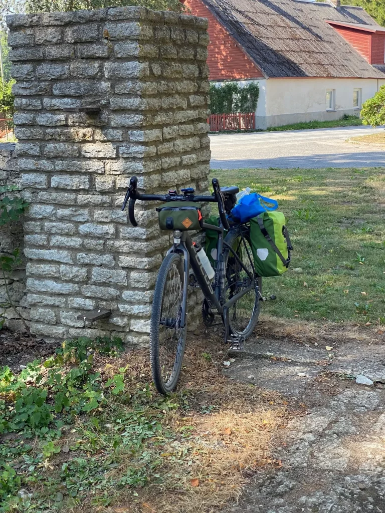 A bicycle leaning against a stone wall.