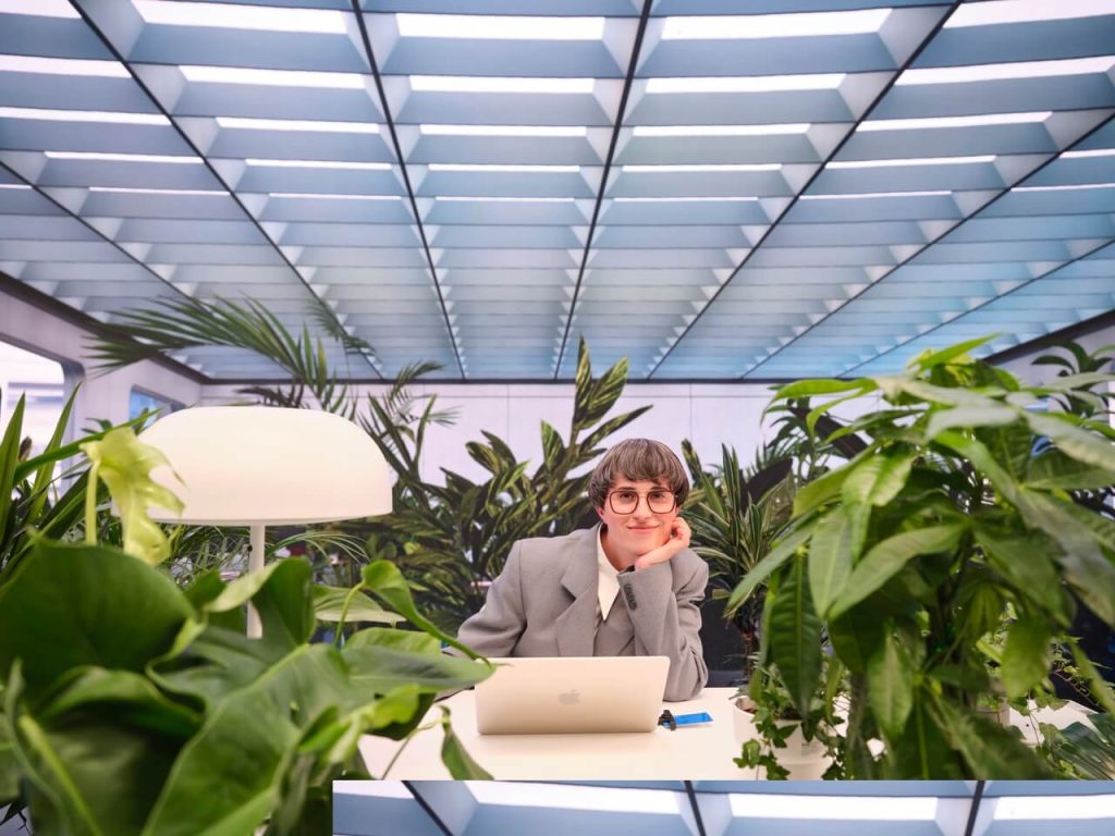 Woman on laptop surrounded by growing plants symbolising the unrivalled opportunities of e-Residency