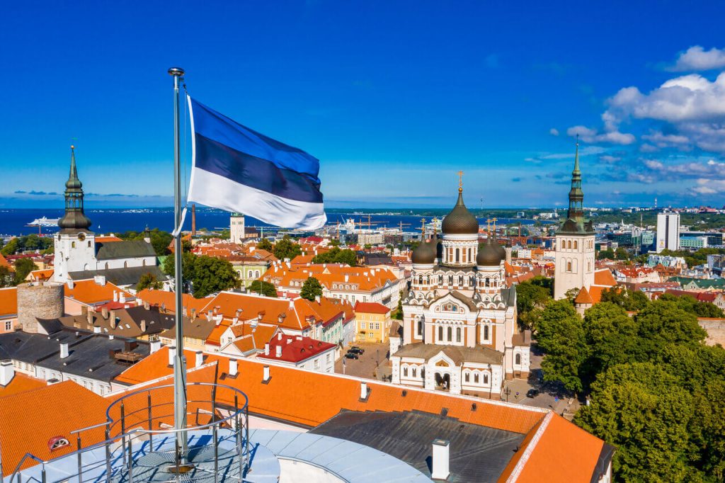 The national flag flying over the rooftops of Tallinn, capital city of Estonia
