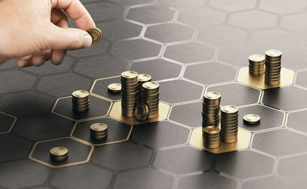 Human hand stacking coins over a black background with hexagonal golden shapes. Concept of finance and startup investment portfolio diversification