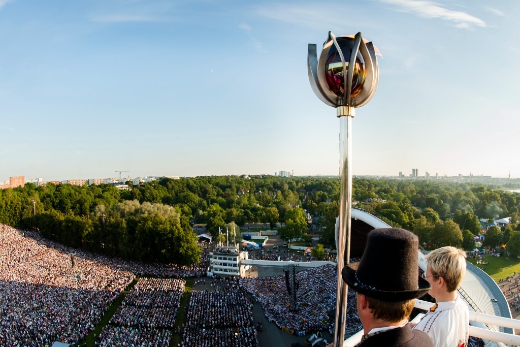 The torch arrives high above Tallinn Song Festival Grounds, at the Song and Dance Festival, one of the unmissable events in Estonia