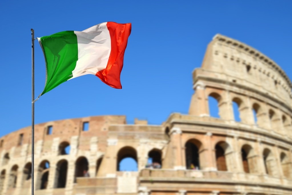 Italian flag with the Colosseum in Rome in the background