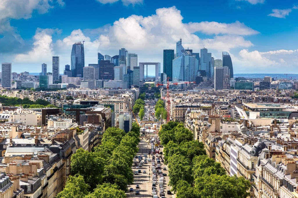 Panoramic aerial view of Paris and The Avenue Charles de Gaulle and business district of La Defence from Arc de Triomphe, France