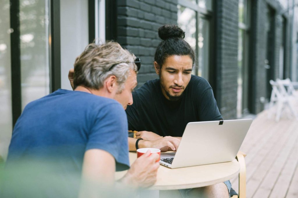 Two startup founders brainstorming on a laptop, showing how to find a co-founder for your business idea