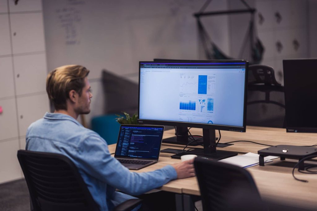 A man works alone on a desktop computer