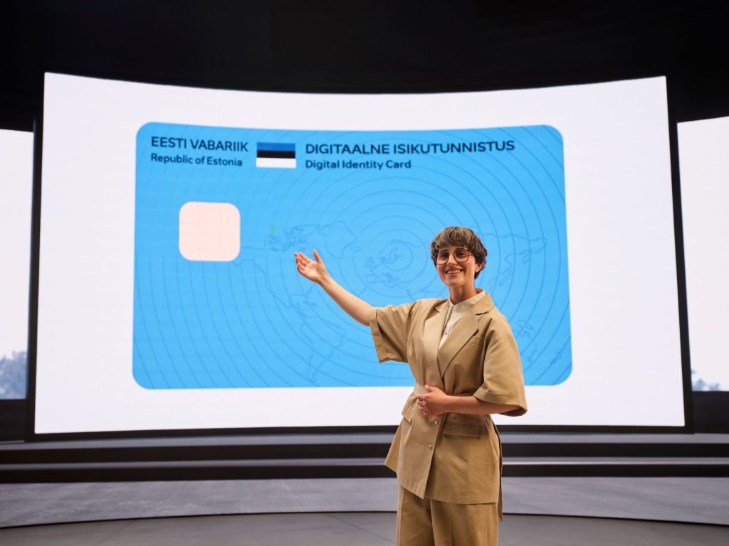 A woman presents Estonia's e-Residency digital ID card