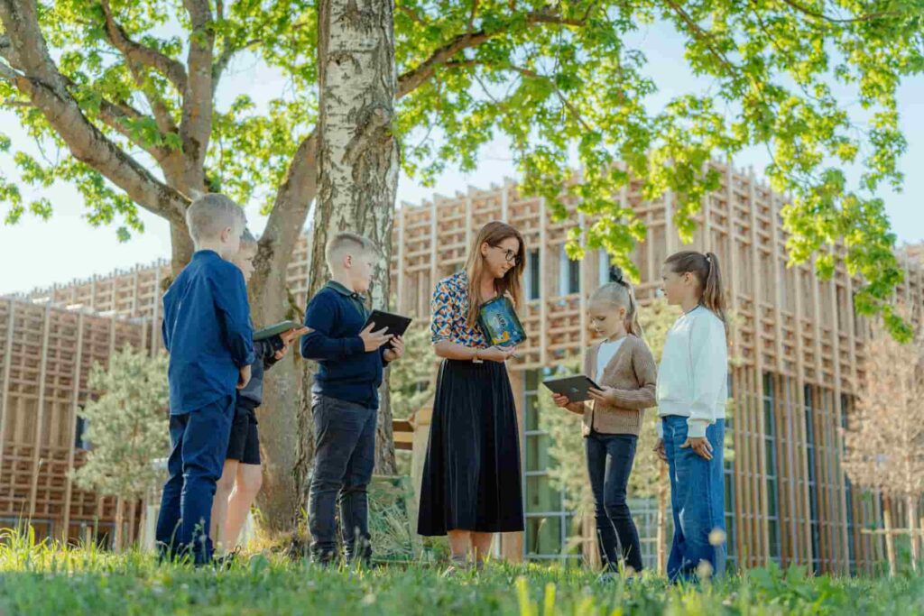 An Estonian teacher teaches students outdoors with technology