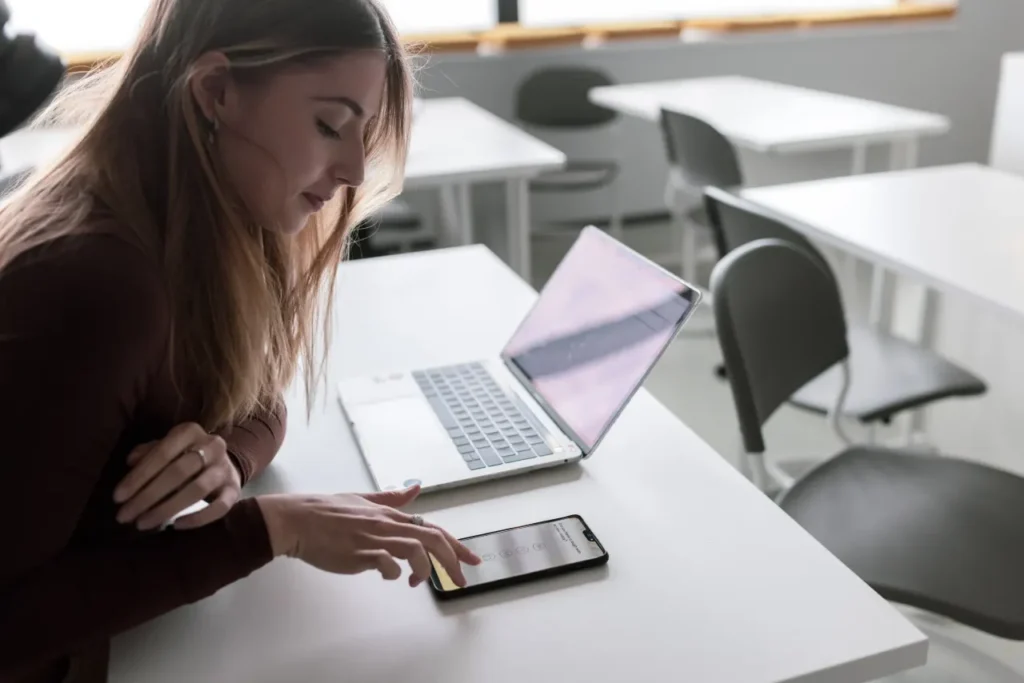 A woman using her laptop and phone