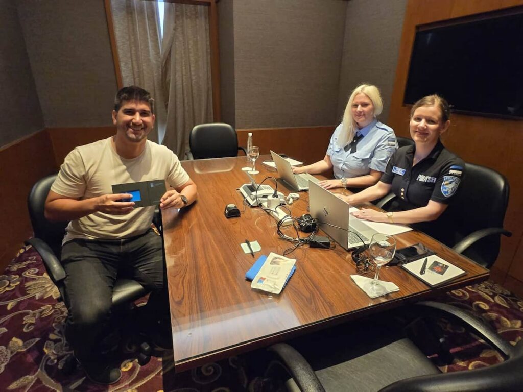 Merike Aspe-Kangro and Kristi Saavaste of the Estonian Police and Border Guard Board issuing an e-resident his card
